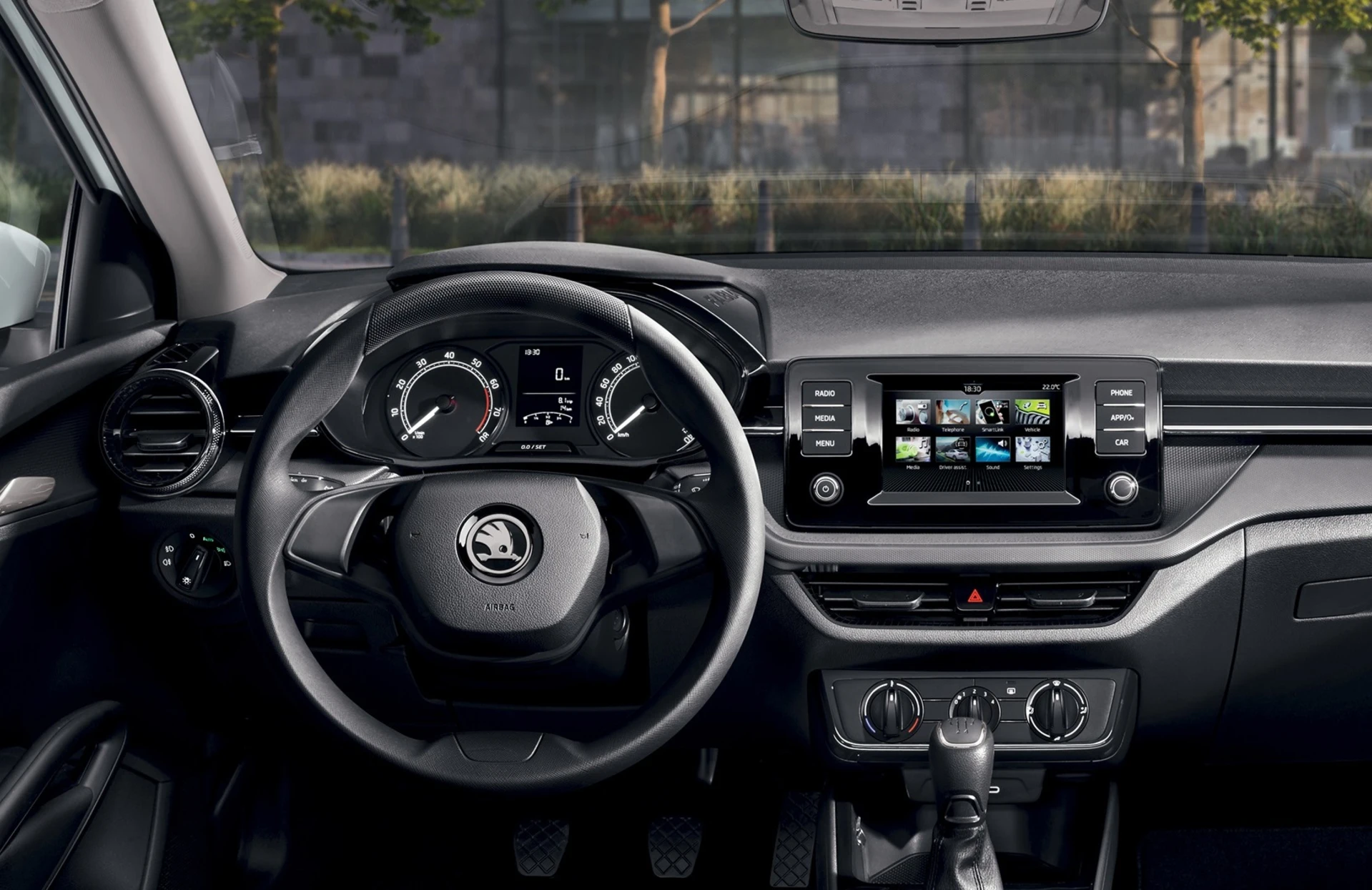 fabia_aussattung-2023_01 Innenraum eines Škoda Fabia 2023 mit Lenkrad und Infotainment-System.