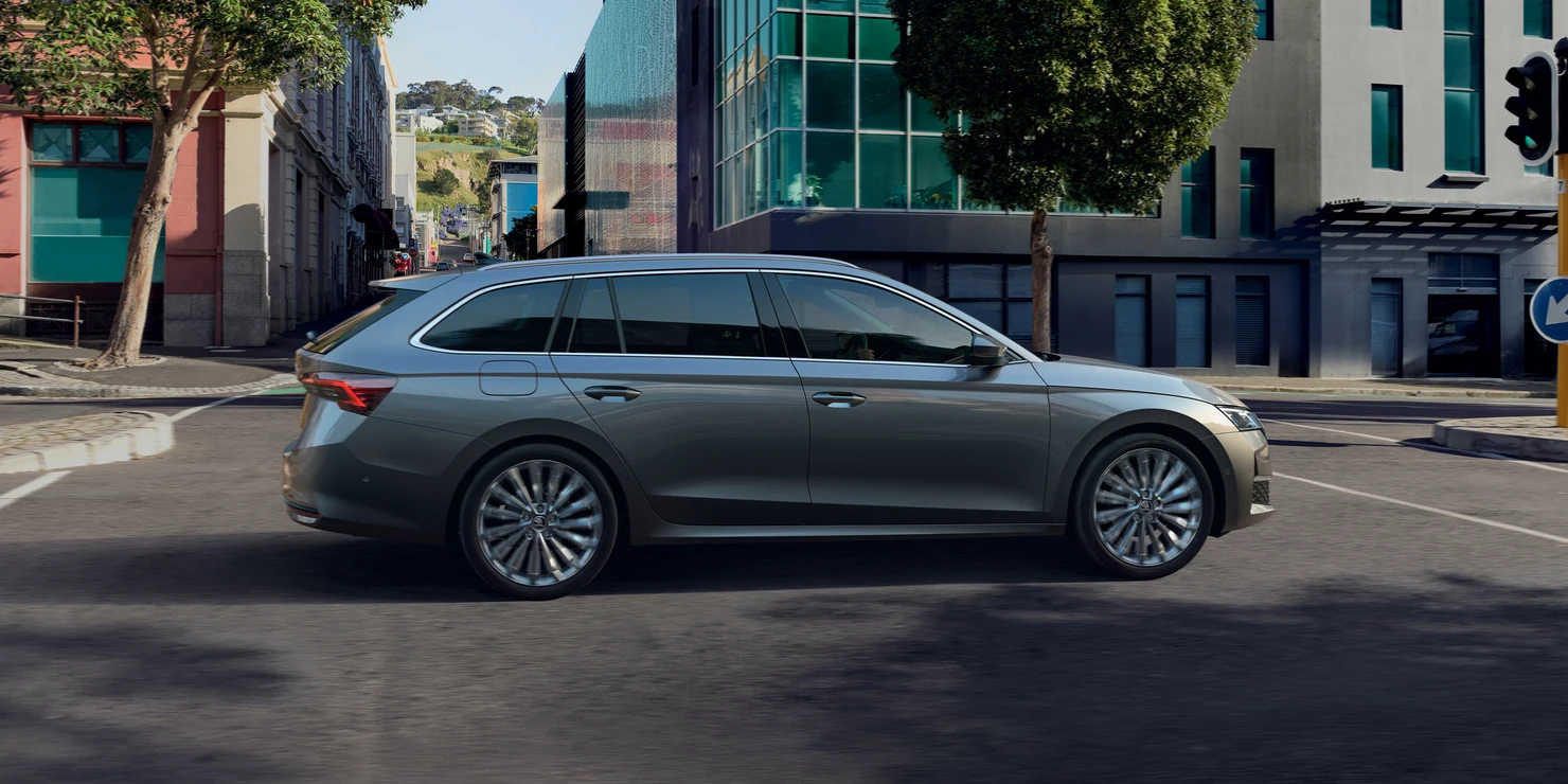 Ein grauer Škoda Octavia Combi 2025 fährt auf einer städtischen Straße.